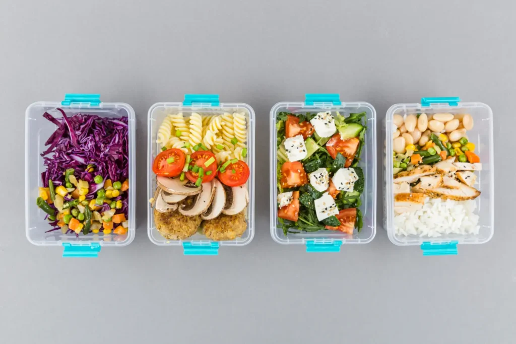 Four meal planning containers filled with a healthy organic weight loss diet lunch.