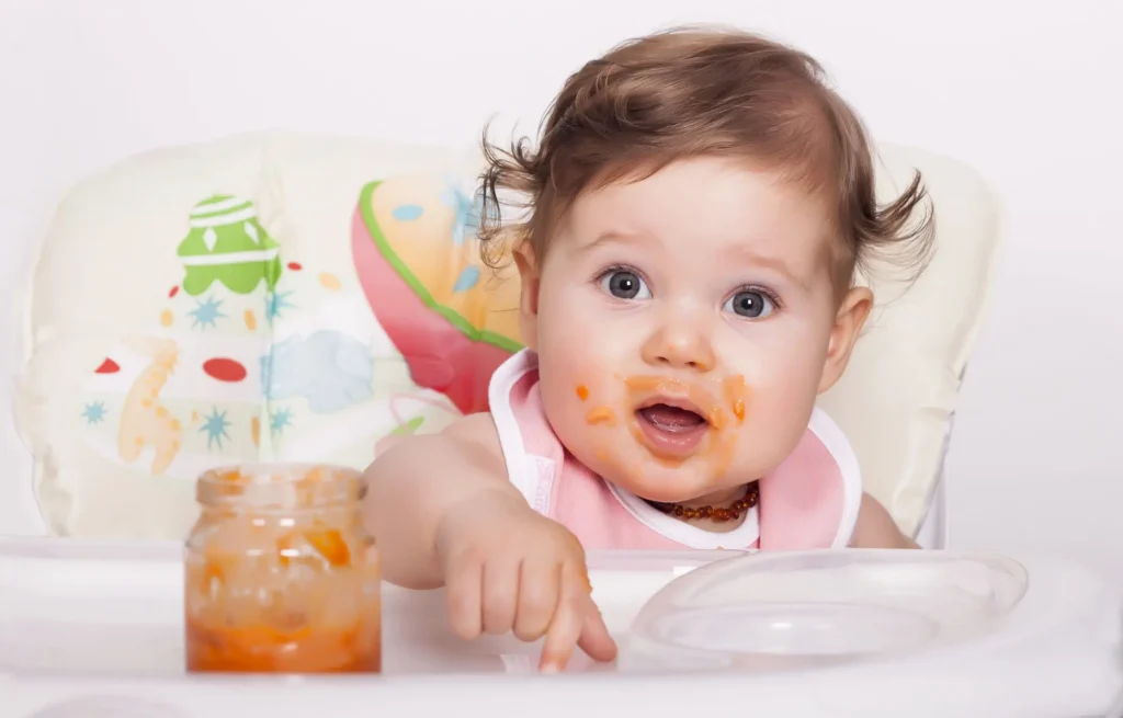 Baby eating homemade organic baby food made from Dirty Dozen-safe ingredients