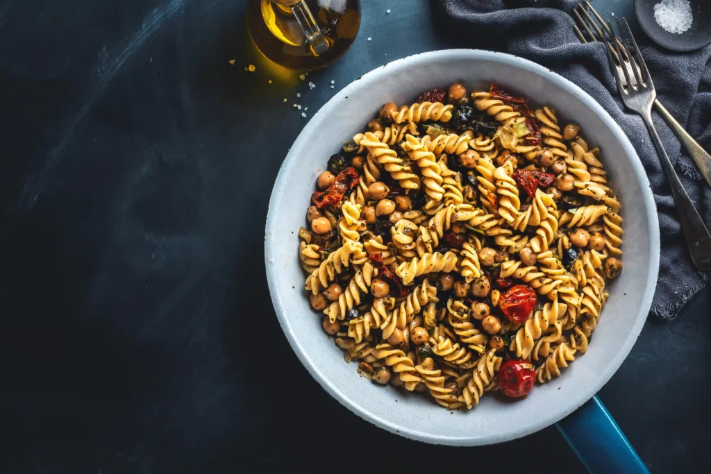 Mediterranean chickpea pasta bowl with olives and veggies