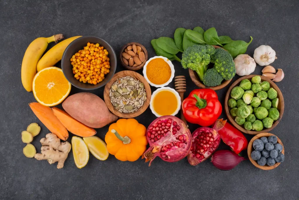 A colorful spread of high antioxidant foods including berries, greens, spices, seeds, and vegetables