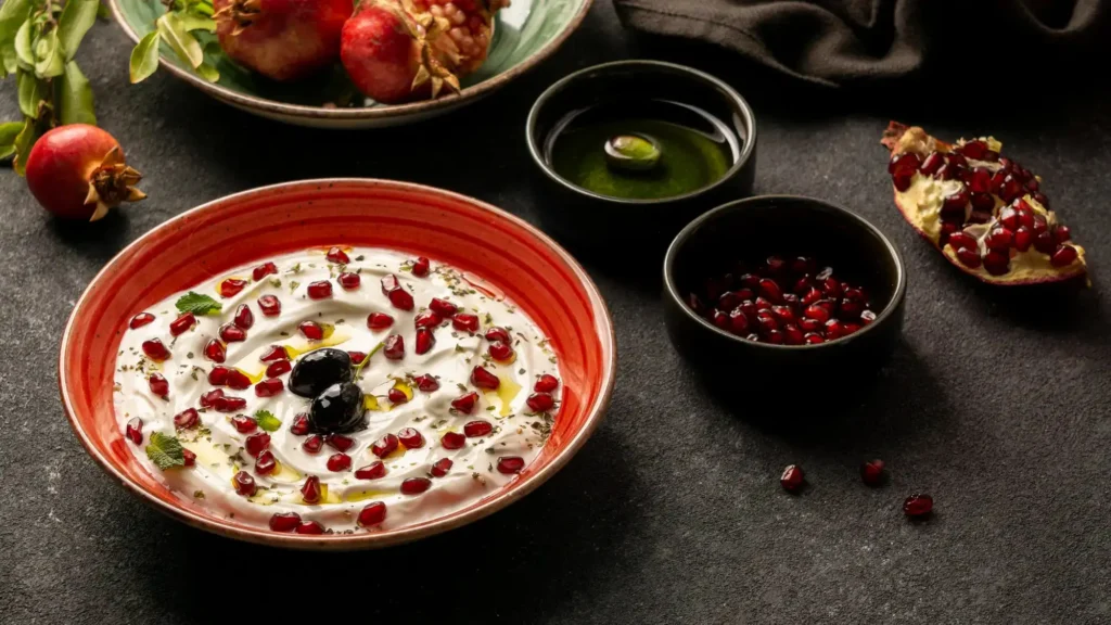Greek yogurt with olive oil, pistachios, and pomegranate seeds